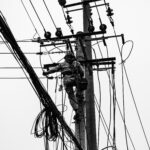 Voltage Sag vs Interruption: Causes, Impact, and Fixes A plant can lose a production line from a blink of power, even when the lights come back almost at once. If you've seen a VFD trip, a contactor drop out, or a PLC reset after a split-second dip, you've seen power quality turn into a production problem. The issue is often not a full outage. It's a short voltage event that sensitive equipment can't ride through. Start with the basics, and the failure starts to make sense. What voltage sag and interruption mean A voltage sag is a short drop in RMS voltage below normal, usually to 10% to 90% of rated voltage, for 0.5 cycles up to 1 minute. In a 415 V system, a brief drop to 280 V or 250 V is a sag, not a blackout. Duration matters. If voltage stays low for more than a minute, that is usually undervoltage, not sag. A sag arrives fast, recovers fast, and can still stop a machine. This quick comparison makes the difference easier to see: EventWhat happensTypical durationVoltage sagVoltage drops but does not go to zero0.5 cycles to 1 minuteVoltage interruptionVoltage is zero or near zeroLess than 1 minuteUndervoltageVoltage stays below normal for longerMore than 1 minute An interruption is more severe because supply is lost completely, or almost completely, for less than a minute. If it clears in a few seconds after auto-reclosing, it is a momentary interruption. If it stays off beyond a minute, it becomes a sustained interruption. Why these events happen The most common cause is a fault on the power system. That could be a single line-to-ground fault, line-to-line fault, double line-to-ground fault, or a three-phase fault. When fault current rises, voltage drops across the network until protection clears the problem. If the fault is on your feeder, you may see a sag first and then an interruption when the breaker opens. If the fault is on another feeder from the same substation, your breaker may never trip, but your plant can still see a bus voltage dip. That is why equipment can trip even when "our feeder never opened." Large motor starting is another frequent cause. An induction motor can draw five to seven times full-load current during start. In a weak system, or where the motor is large compared with the transformer, that inrush can create a temporary sag. Transformer energization, capacitor switching, welding loads, arc furnaces, and sudden heavy loading can do the same. Why a tiny dip can stop a large machine > The main motor may ride through a sag, but the control power often won't. Older plants had more electromechanical loads, and many of them tolerated short dips. Modern plants rely on PLCs, VFDs, servo drives, electronic power supplies, sensors, relays, and SCADA. Those devices make automation possible, but many are more sensitive to voltage dips than the motor they control. Massive steel control panels and heavy machinery dominate the floor as overhead lights cast a chaotic, flickering glow. Sharp shadows and sparks suggest a sudden surge in the facility power grid. [https://user-images.rightblogger.com/ai/f382171e-d1b1-4320-b7eb-289d9b53ee27/industrial-factory-power-instability-93e17dc7.jpg] A short sag may not stop a spinning motor because inertia keeps it moving. Still, the contactor coil can drop out, the VFD can detect undervoltage, and the PLC power supply can reset. Once the control chain breaks, the process stops. In process plants, that can mean lost batches, reset time, scrap, labor loss, and delayed delivery. Magnitude and duration both matter. Some equipment can tolerate 80% voltage for five cycles, but not 40% for the same time. That is why ride-through curves matter, and why event recording matters too. Good monitoring tools, such as monitoring power quality with PME 2024 R2 [https://www.interestingautomation.com/schneider-pme-2024-r2/], help capture minimum voltage, duration, and affected phases. Practical ways to reduce voltage sag problems The most cost-effective fix starts with the weak point. If a 200 kW machine trips because a 230 V PLC supply resets, you usually do not need to protect the whole machine. You need to protect the control power. * Specify ride-through performance when buying critical PLCs, drives, relays, and controls. * Add a small UPS, DC backup, or capacitor ride-through module for control power. * Use a voltage sag compensator or dynamic voltage restorer for sensitive process loads. * Apply online UPS systems where transfer time cannot be tolerated. * Consider motor-generator or flywheel systems where short interruptions happen often. * Use static transfer switches only when the two sources are truly independent. Source quality matters too. Utilities reduce events with better protection coordination, faster fault clearing, line maintenance, tree trimming, and feeder automation. On the plant side, grid automation and fault visibility also help, which is why tools for using Easergy T300 for fault detection [https://www.interestingautomation.com/brief-explain-easergy-t300-features-benefits-and-complete-guide/] are relevant in systems that need faster disturbance response. Final thoughts A blink in voltage can do more damage to production than a short outage, because the failure often happens inside the control system before anyone sees a breaker trip. That is the core lesson behind voltage sag and interruption studies. The best fix is rarely the biggest one. Find what actually trips, measure how deep and how long the event lasts, and protect the most sensitive part first. A brief dip should not turn into hours of downtime.